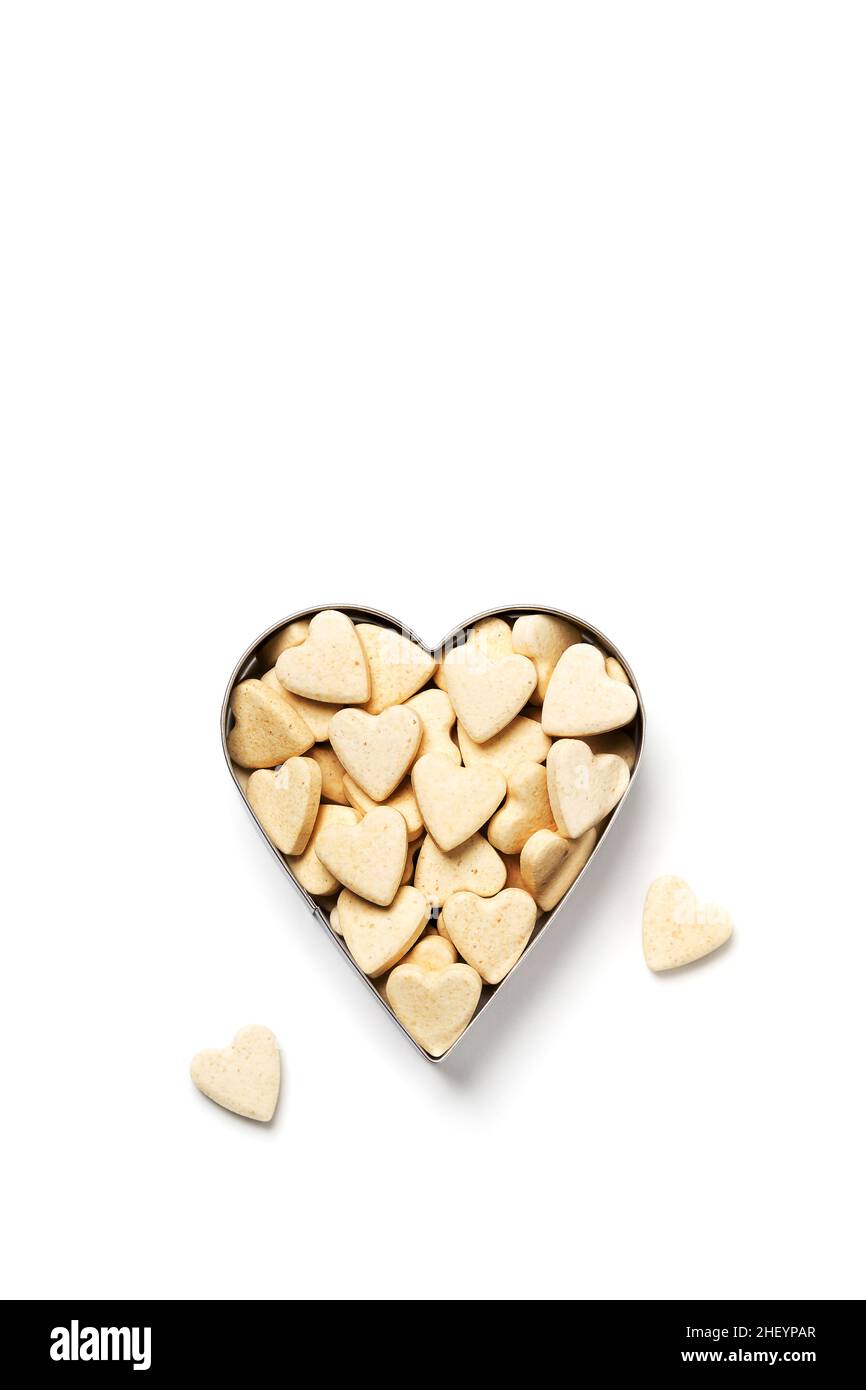 Heart-shaped little sweet cookies in heart form on white background, minimalistic saint valentine`s day greeting card Stock Photo